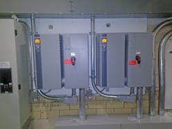 PHOTO A. Cooling-load monitoring system consisting of cooling-air dry-bulb-temperature and relative-humidity sensors for two 125-hp enclosed VFDs