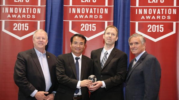 ASHRAE President Thomas H Phoenix left and AirConditioning Heating and Refrigeration Institute Chairman Ed Purvis right congratulate Lin Sun and Mogens Rasmussen of Danfoss on receiving the 2015 AHR Expo Product of the Year award