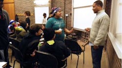 Jason Coleman confers with a group of high-school students.