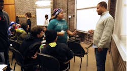 Jason Coleman confers with a group of highschool students Jason Coleman confers with a group of highschool students