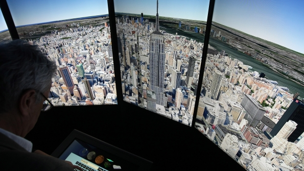 A visitor looks at a threedimensional rendering of Manhattan using Google Earth software during the official opening party of Google offices in Berlin Germany Sept 26 2012 Photo by Adam BerryGetty Images