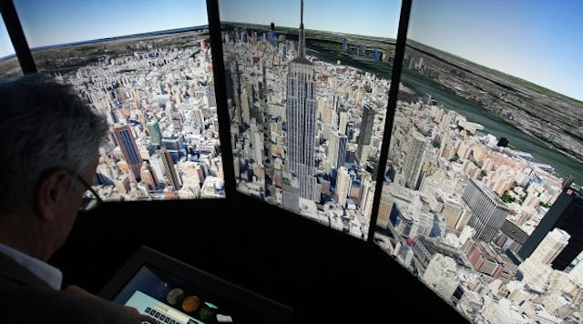 A visitor looks at a three-dimensional rendering of Manhattan using Google Earth software during the official opening party of Google offices in Berlin, Germany, Sept. 26, 2012. (Photo by Adam Berry/Getty Images)
