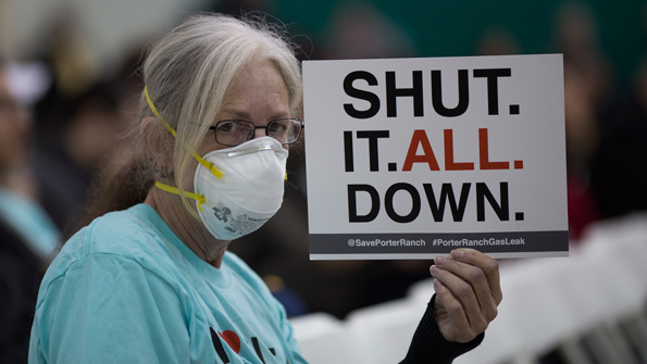 A woman holds a sign while attending a public hearing before the South Coast Air Quality Management District regarding a proposed stipulated abatement order to stop the naturalgas leak in Granada Hills near Porter Ranch Calif on Jan 16 2016 Photo by David McNewGetty Images
