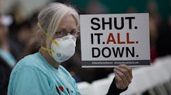 A woman holds a sign while attending a public hearing before the South Coast Air Quality Management District regarding a proposed stipulated abatement order to stop the natural-gas leak in Granada Hills, near Porter Ranch, Calif., on Jan. 16, 2016. (Photo by David McNew/Getty Images)