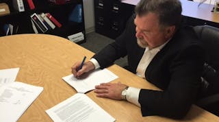 Nationwide Boiler&rsquo;s President Larry Day signing the final acquisition documents Oct. 16, 2017, for Pacific Combustion Engineering/Ponder Burner Co.