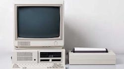 Old personal computer. The system unit, floppy drive, CRT monitor, printer and keyboard on white background.