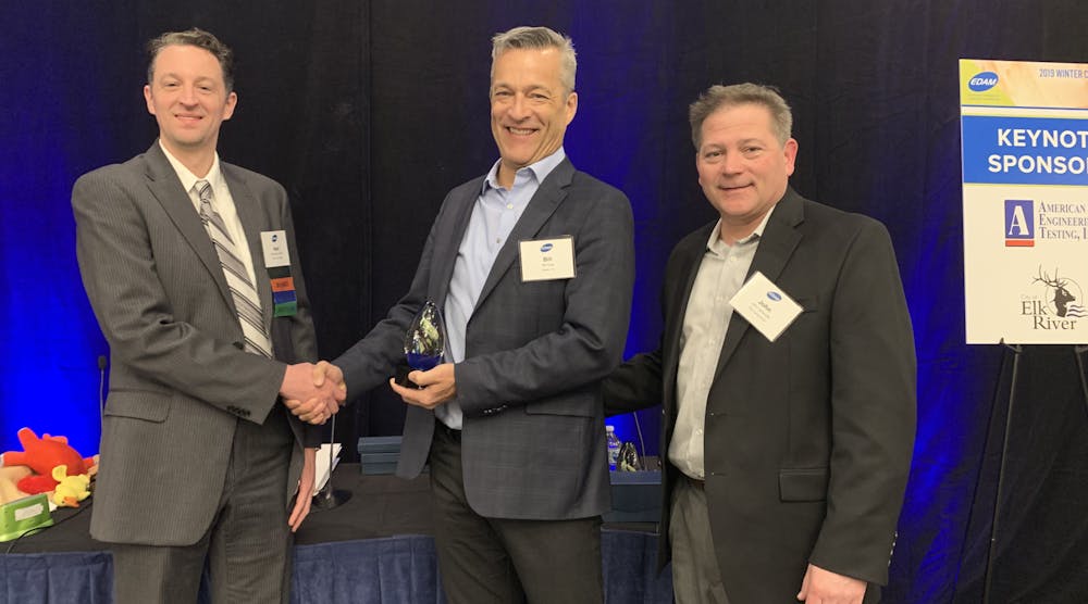 EDAM President Matt Brown (left) awards the Project of the Year trophy to Uponor North America President Bill Gray (center) and PCL Construction Director of Project Development John Jensvold.