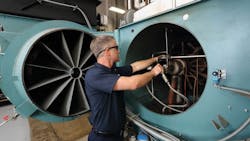 A technician performs a combustion tuneup A technician performs a combustion tuneup