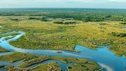 A sky view photo of a river running through grassy plains A sky view photo of a river running through grassy plains