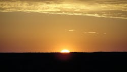 The sun rising over the Australian Desert The cool of the night was about to vanish in a wave of heat as the brightening light washed over the desert and Ayers Rock The sun rising over the Australian Desert The cool of the night was about to vanish in a wave of heat as the brightening light washed over the desert and Ayers Rock