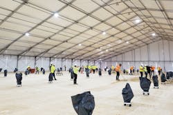 Workers prepare the flooring inside a climate-controlled tent under construction at SUNY, Stony Brook. Workers prepare the flooring inside a climate-controlled tent under construction at SUNY, Stony Brook.