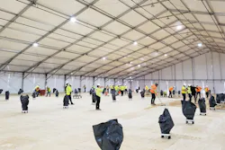 Workers prepare the flooring inside a climate-controlled tent under construction at SUNY, Stony Brook. Workers prepare the flooring inside a climate-controlled tent under construction at SUNY, Stony Brook.