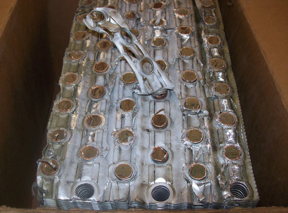 Figure (8): A view of the same 6 row chilled water coil cross section after 90 days. After the coil was cleaned up, it failed due to freeze damage, and we were able to slice the coil in half. Despite our skepticism, PurgenixMatrix&trade; was observed to completely penetrate and clean the coil airside (between the tightly spaced aluminum fins) to create a cleared airflow path for renewed air to chilled water heat transfer.