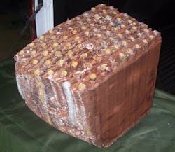 Figure (9): A view of an 8 row chilled water cooling coil. This cooling coil also froze and burst while in service, so we were able to slice it in half. As shown, an 8 row coil is extremely thick in the direction of airflow. As a result, it is impossible to manually clean out a fouled airside. Rather, manual coil cleaning just packs the fouling tighter into the center of the coil. Figure (9): A view of an 8 row chilled water cooling coil. This cooling coil also froze and burst while in service, so we were able to slice it in half. As shown, an 8 row coil is extremely thick in the direction of airflow. As a result, it is impossible to manually clean out a fouled airside. Rather, manual coil cleaning just packs the fouling tighter into the center of the coil.