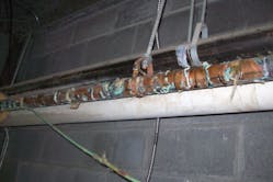 Figure (3): A view of another failed copper domestic water piping system at another jail. This piping system had failed beyond repair and was replaced with a plastic domestic water piping system at a cost of $800,000.