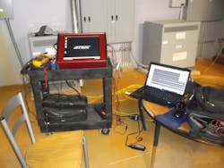 Figure (5): A view of the AstroNova testing equipment that was used as part of the professional testing at the school. The AstroNova testing equipment is a high-end data logging system. Data logging was done for the HVAC piping system, as well as the plumbing piping system and the fire protection (sprinkler) piping system. Each AstroNova test was done for three minutes, collecting 900,000 electrical samples during each test (180 seconds per test). That equals 5,000 samples per second. Figure (5): A view of the AstroNova testing equipment that was used as part of the professional testing at the school. The AstroNova testing equipment is a high-end data logging system. Data logging was done for the HVAC piping system, as well as the plumbing piping system and the fire protection (sprinkler) piping system. Each AstroNova test was done for three minutes, collecting 900,000 electrical samples during each test (180 seconds per test). That equals 5,000 samples per second.