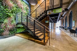 The building’s interior encourages occupant movement via a large, central staircase. The building’s interior encourages occupant movement via a large, central staircase.