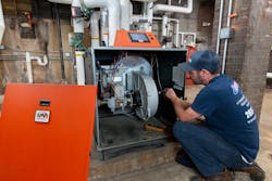 Edgerton tech Mike Lennon checks electrical connection on the AMP boiler. Edgerton tech Mike Lennon checks electrical connection on the AMP boiler.