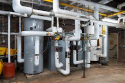 When the DHW load exceeds the input of the co-gen system, supplemental capacity is provided by the AMP boiler through the use of two H2O Max instantaneous, indirect-fired water heaters. When the DHW load exceeds the input of the co-gen system, supplemental capacity is provided by the AMP boiler through the use of two H2O Max instantaneous, indirect-fired water heaters.