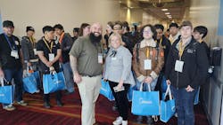 Bush and industry guide C.J. Maderios of Spirotherm Inc. share some cool AHR Expo swag with local students. Bush and industry guide C.J. Maderios of Spirotherm Inc. share some cool AHR Expo swag with local students.